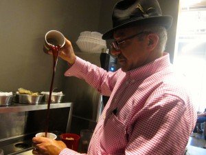 Philz Coffee founder Phil Jaber demonstrates how to make one of his specialized cups of coffee at Thursday’s soft opening event in Santa Monica.
