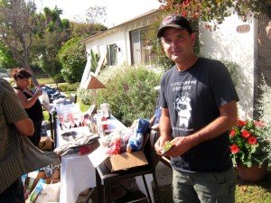 Ed Moosbrugger of Santa Monica completes a sale during Saturday’s citywide yard sale event.