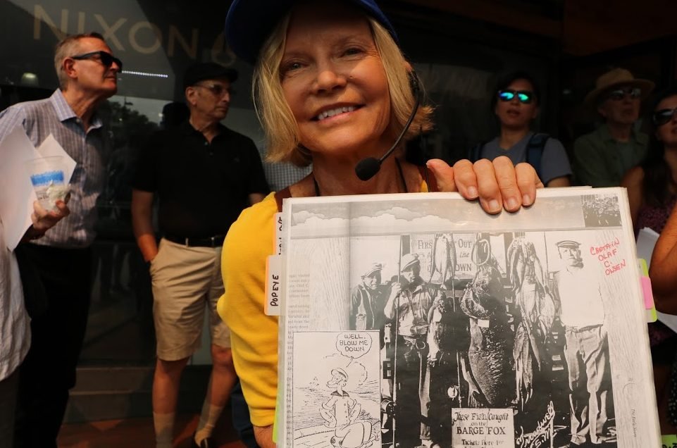 Conservancy volunteer Thomasine Rogas shows a historical photograph of the sailor whom the cartoon character Popeye is supposedly based on.