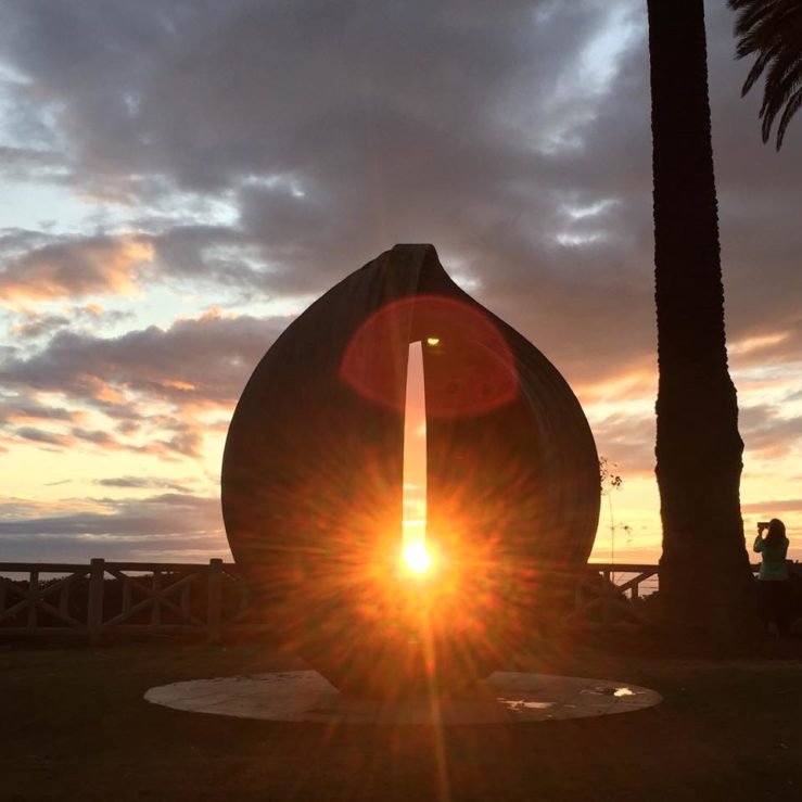 The Winter Solstice sunset as seen from Palisades Park through the sculpture "Gestation." Photo By Gary Kavanagh.